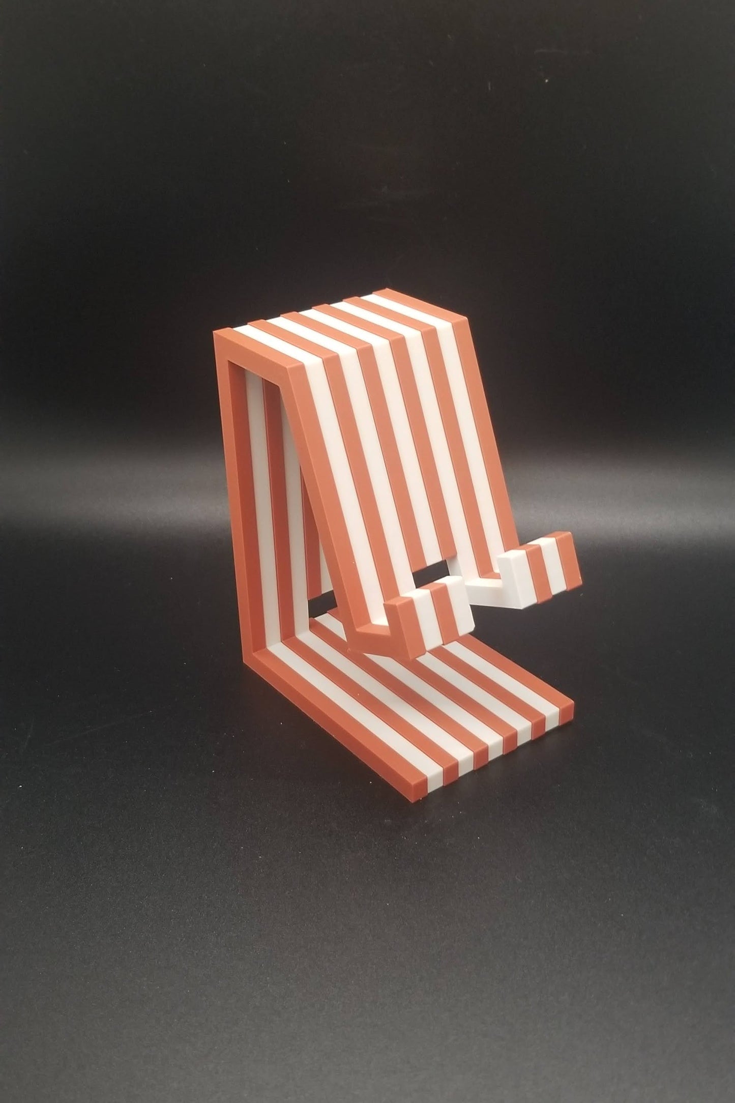 Red and white striped object on a black background