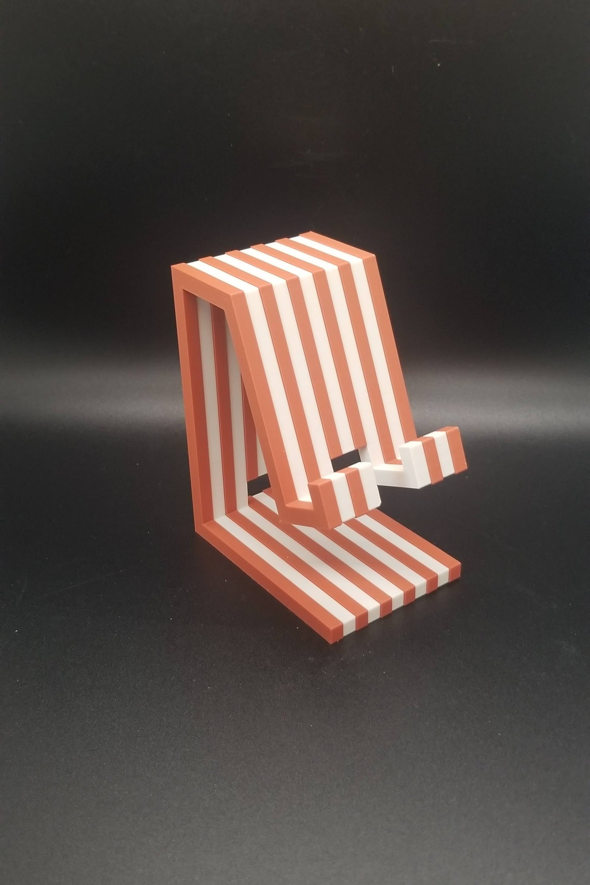 Red and white striped object on a black background