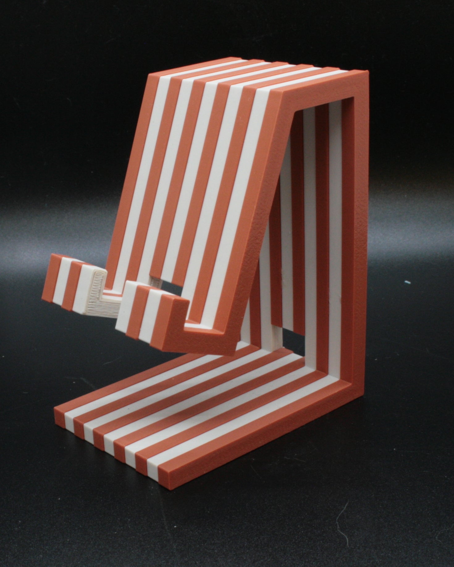 Red and white striped chair model on a black background